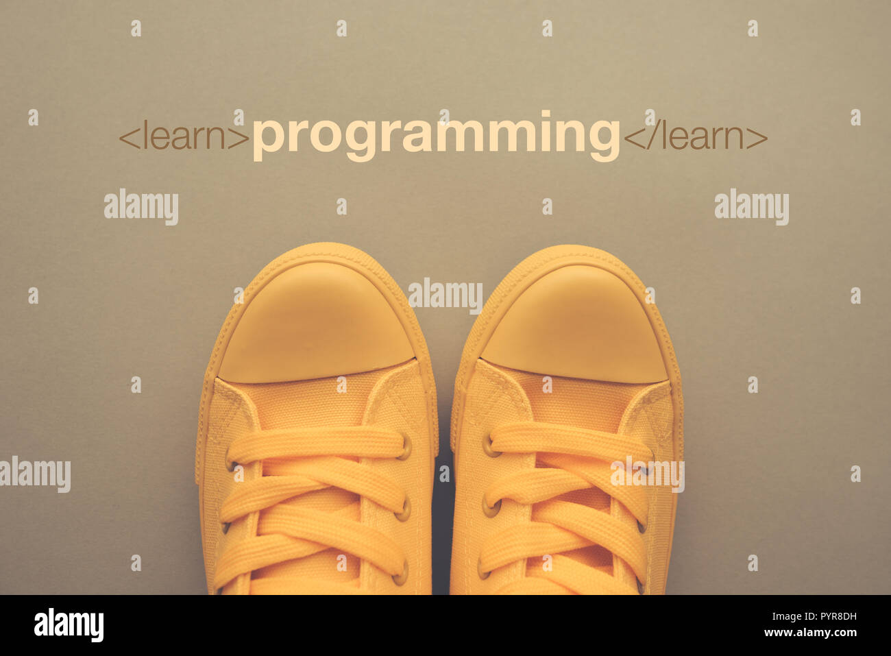 Learn programming concept, young student standing above the text, top view Stock Photo