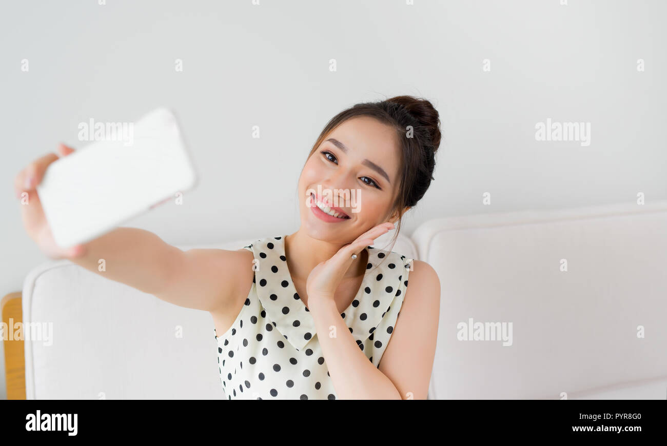 Smiling pretty woman taking a selfie using smartphone. Stock Photo