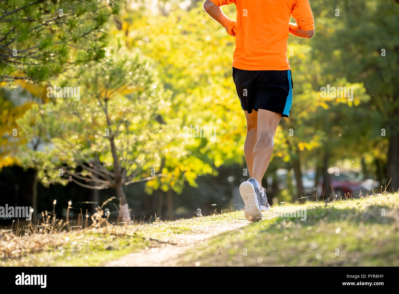 Back view of sport man with ripped athletic and muscular legs running