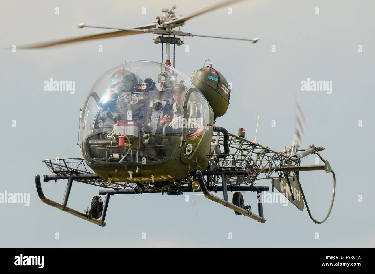 Bell 47G vintage helicopter G-MASH representing the medical evacuation helicopter used in the TV programme MASH of the Korean War flying Stock Photo