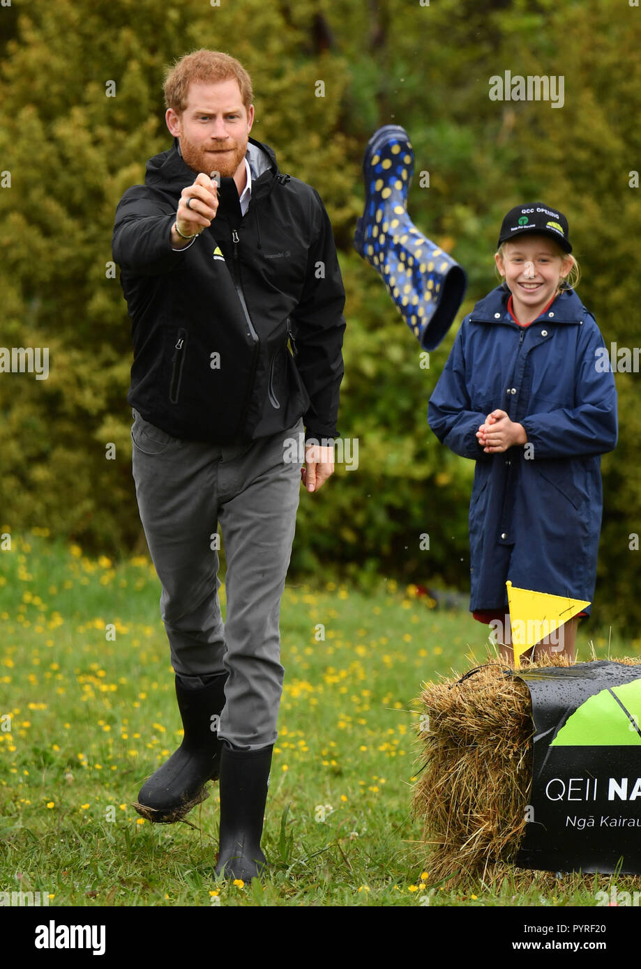 The Duke of Sussex, takes part in a 'welly wanging' contest during a visit to Redvale on Auckland's North Shore to dedicate a 20-hectare area of native bush to the Queen's Commonwealth Canopy, New Zealand. Stock Photo