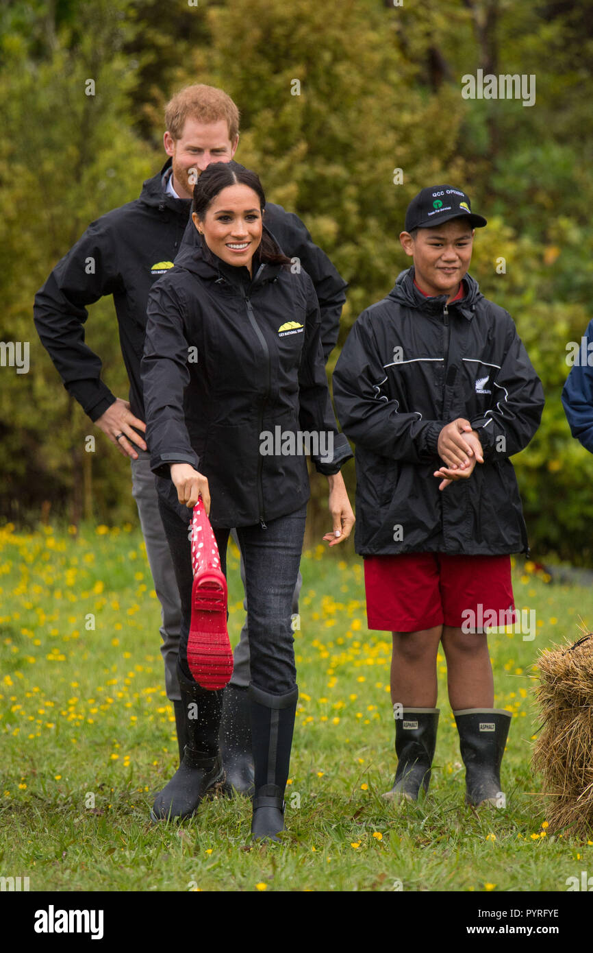 The Duchess of Sussex takes part in a welly wanging contest following a dedication of an area of bush to the Queen's Commonwealth Canopy, in Redvale on the North Shore, on day three of the royal couple's tour of New Zealand. Stock Photo