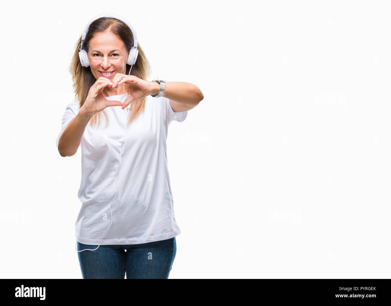 Middle age hispanic woman listening to music wearing headphones over ...