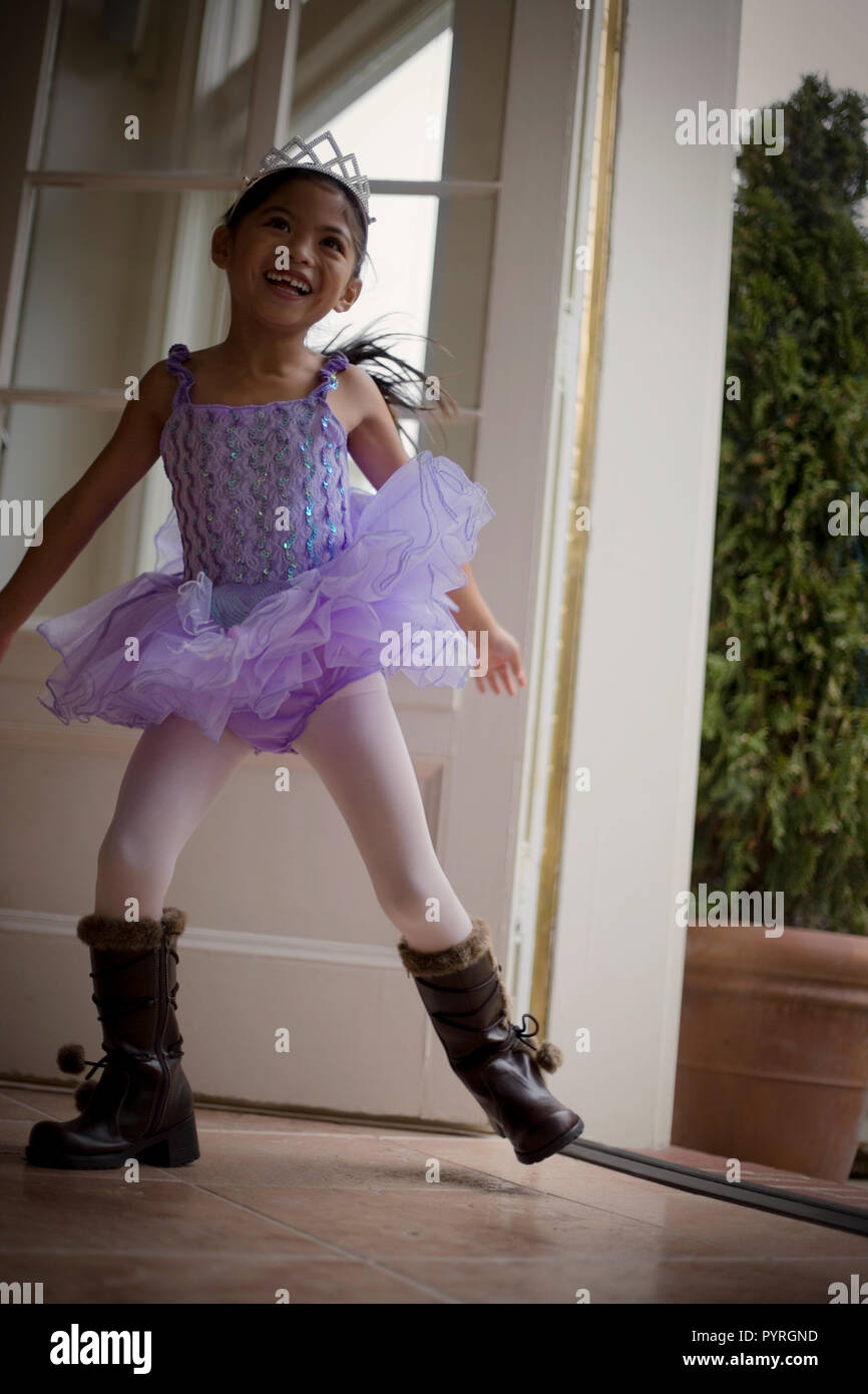 Young girl dancing while wearing brown leather boots and a tutu Stock Photo  - Alamy