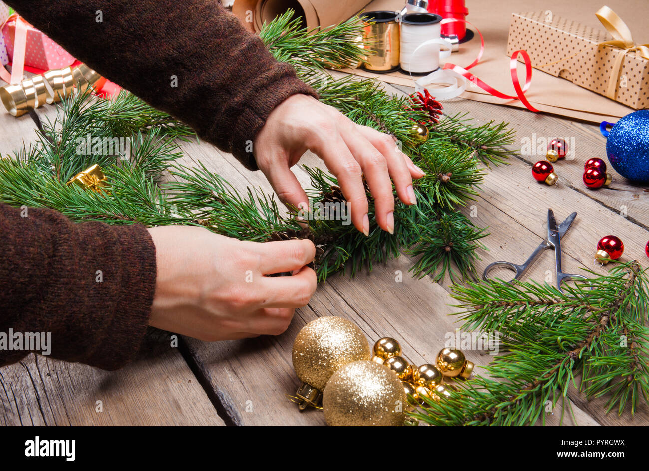 Woman making Christmas wreath Stock Photo
