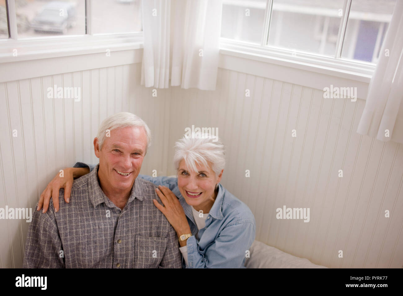 Senior couple inside their home Stock Photo - Alamy
