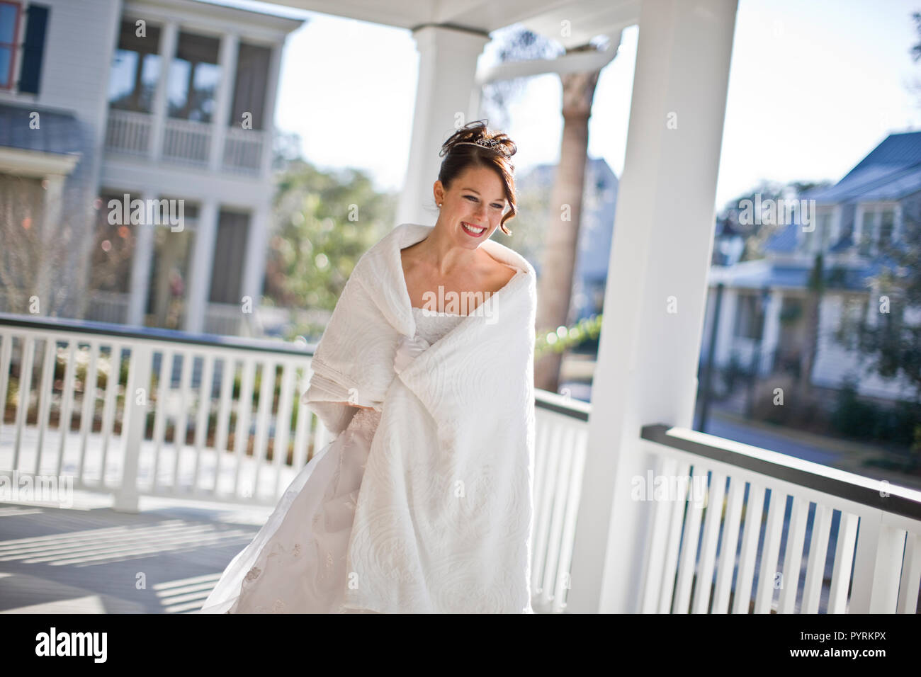 Bride Standing On Deck Wrapped In White Shawl Stock Photo