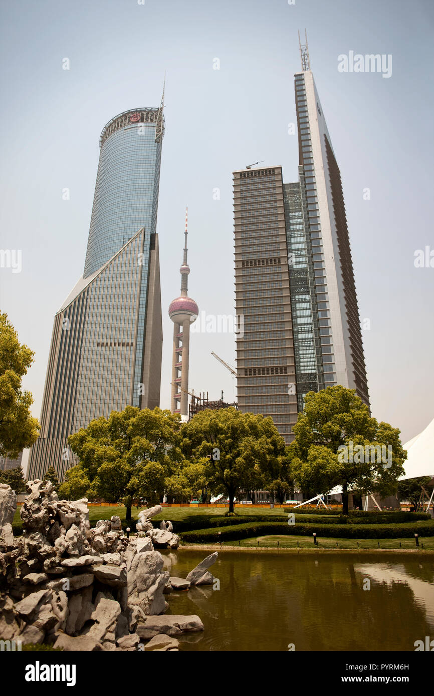Tall skyscrapers towering behind a green city park. Stock Photo