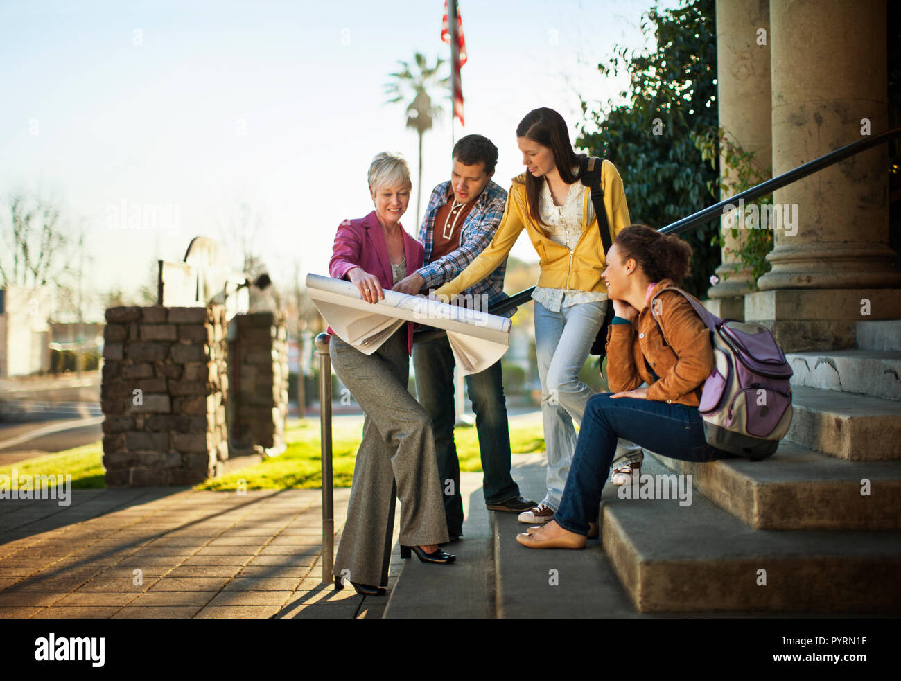 Colleagues discussing architectural plans together. Stock Photo