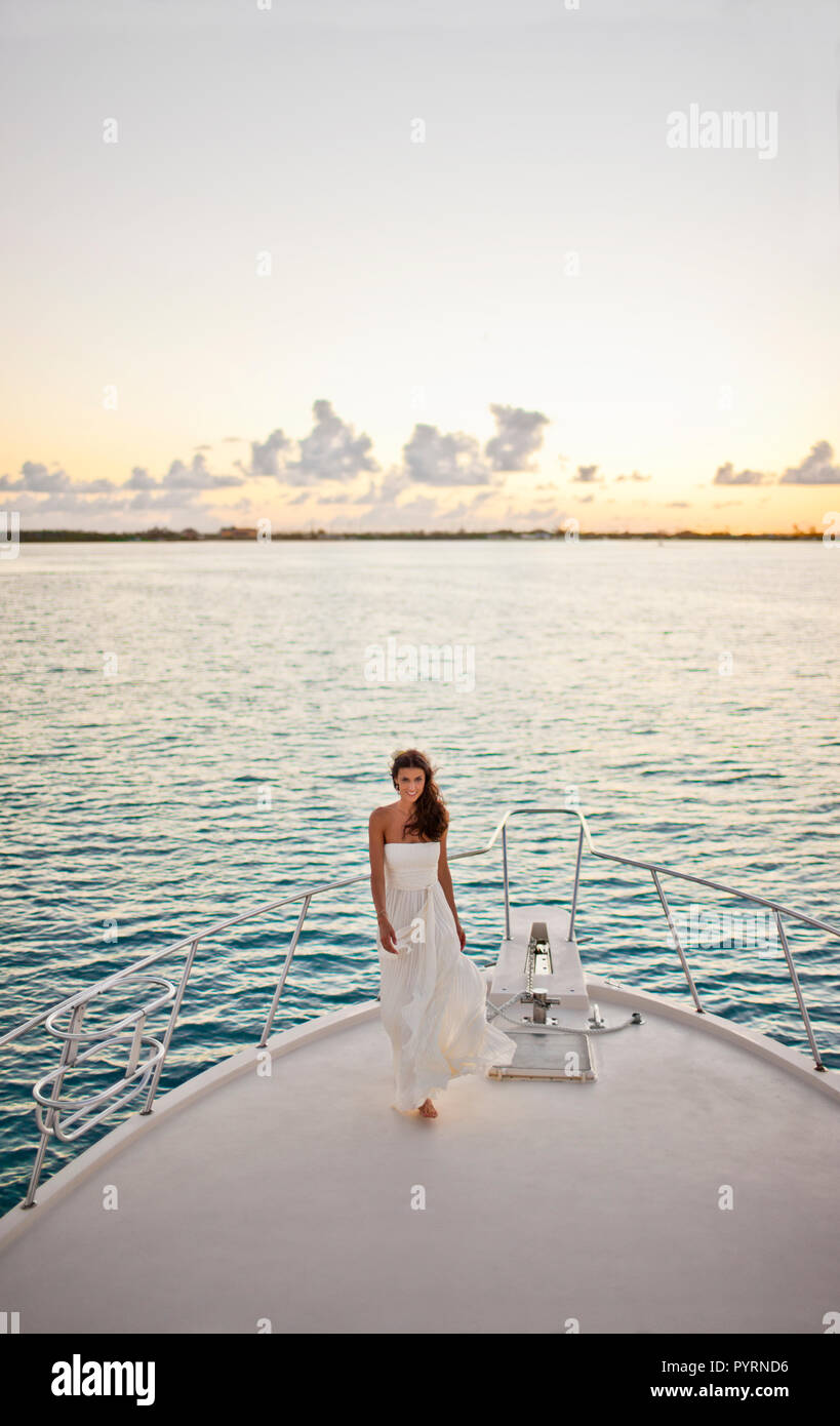 Portrait of a bride standing on the prow of a boat. Stock Photo
