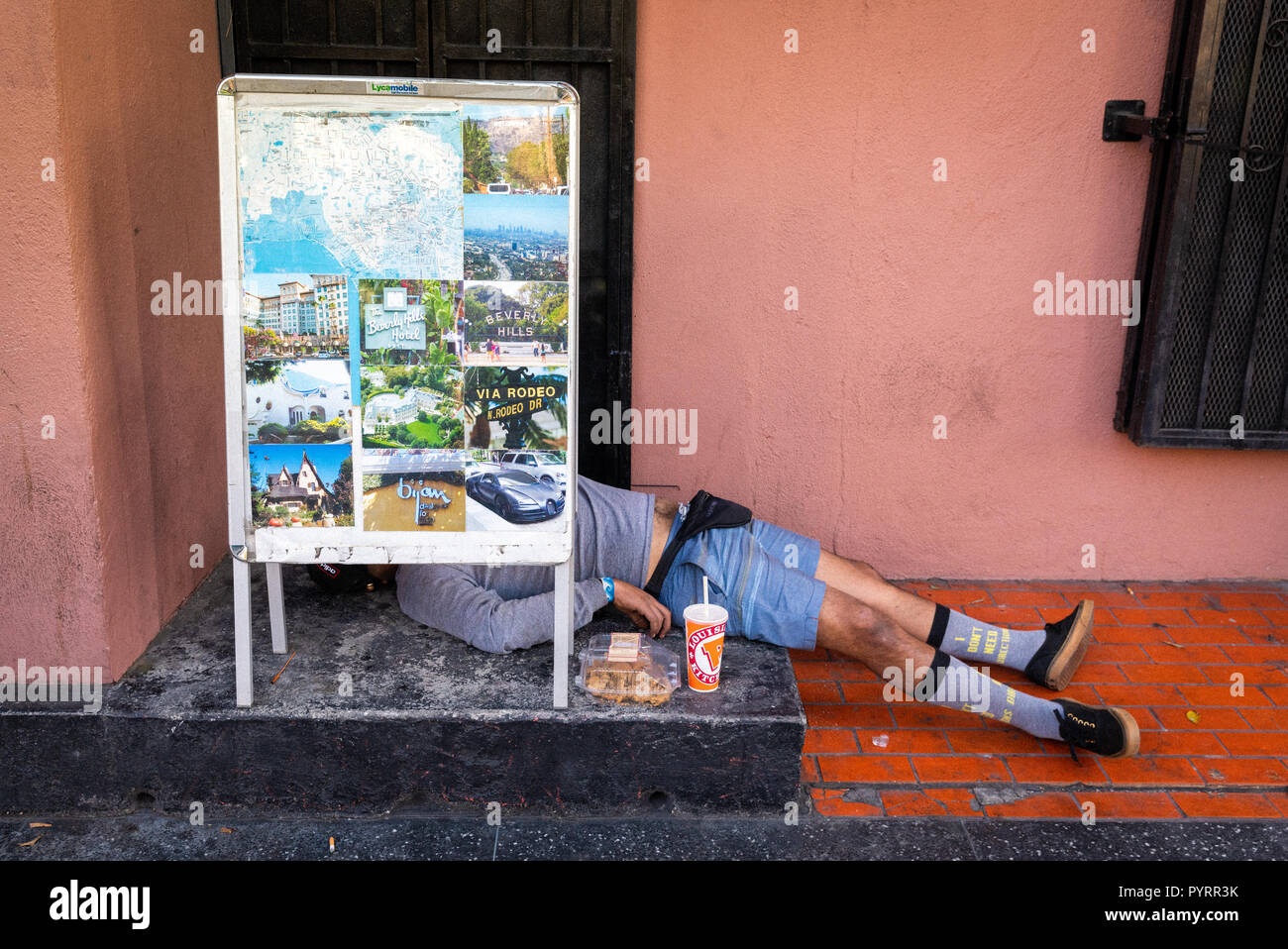 Man laying on his back on Hollywood Boulevard, Los Angeles, California. Stock Photo