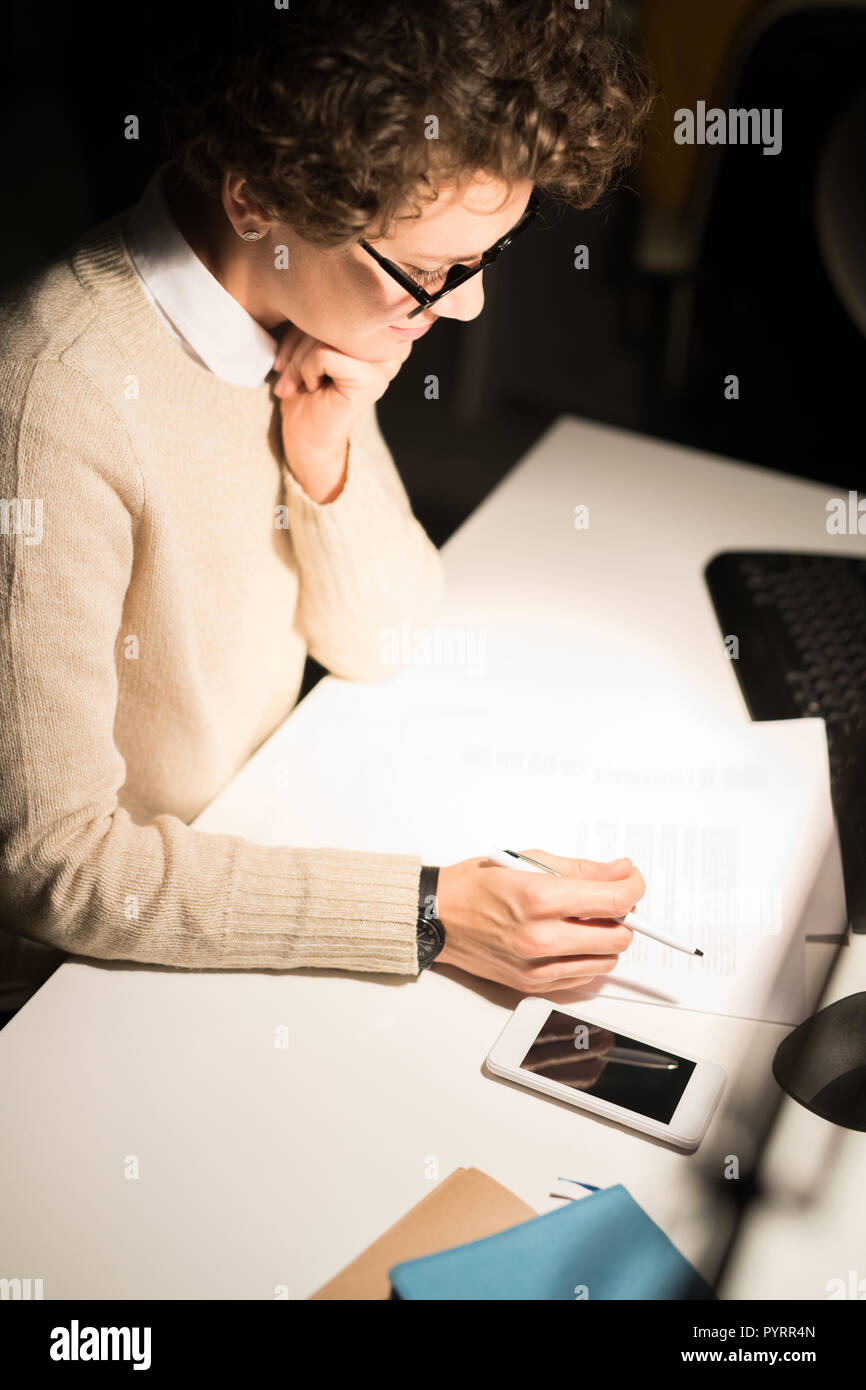 Young Woman Working at Night Stock Photo