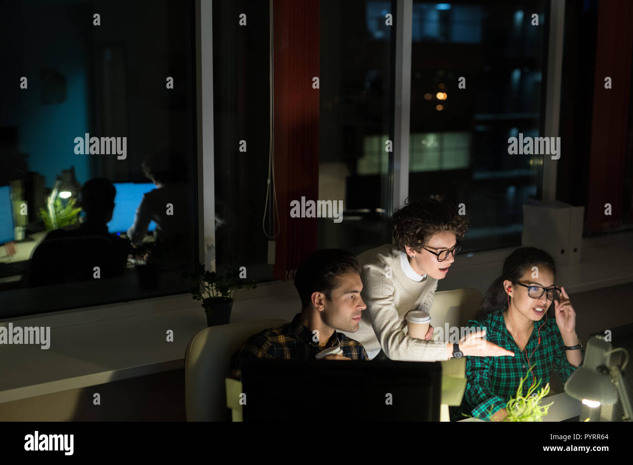 Woman working late in dark office hi-res stock photography and images ...