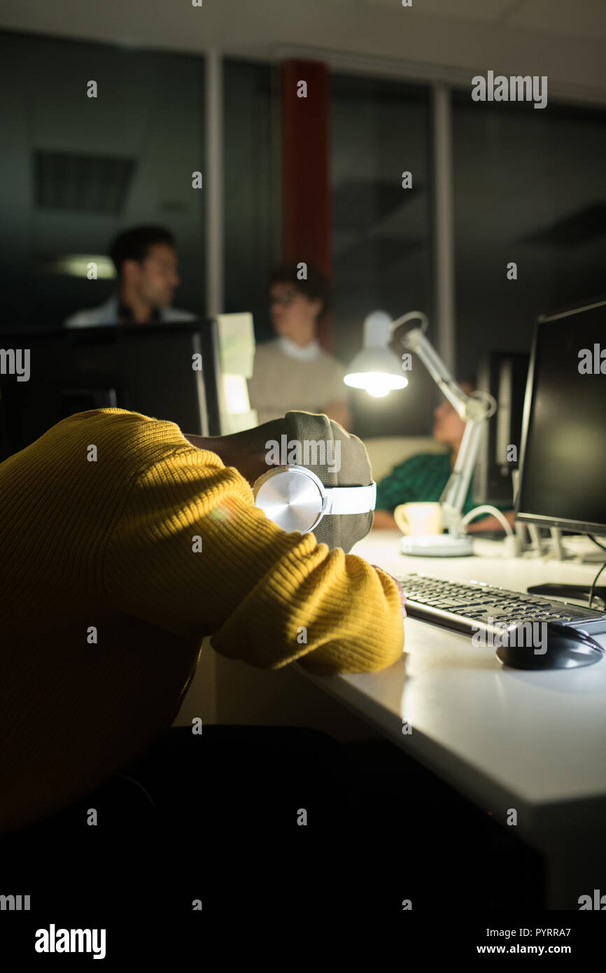 Young Man Sleeping at Workplace Stock Photo