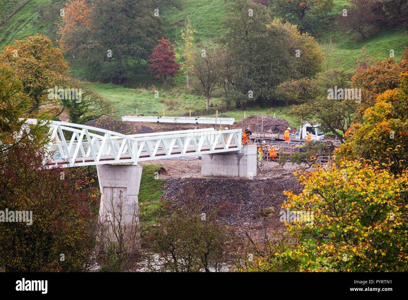 Construction on a new footbridge across the River Ribble after the old one was severely damaged by Sotrm Desmond flooding in Hurst Green, Lancashire,  Stock Photo
