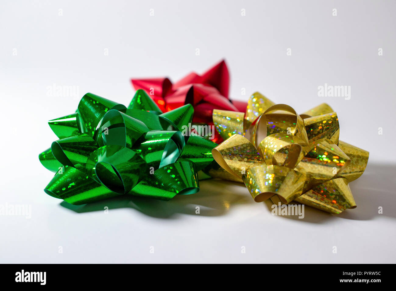 Christmas Holiday Satin Bows. Green, Red, Gold. Room for copy. Light White Background. Brillant Color. Stock Photo