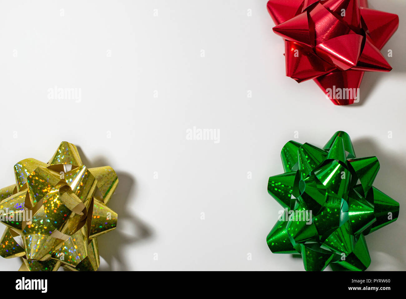 Christmas HolidaySatin Ribbon Bows, Gold, Red, Green. Light White Background. Room for copy. Stock Photo