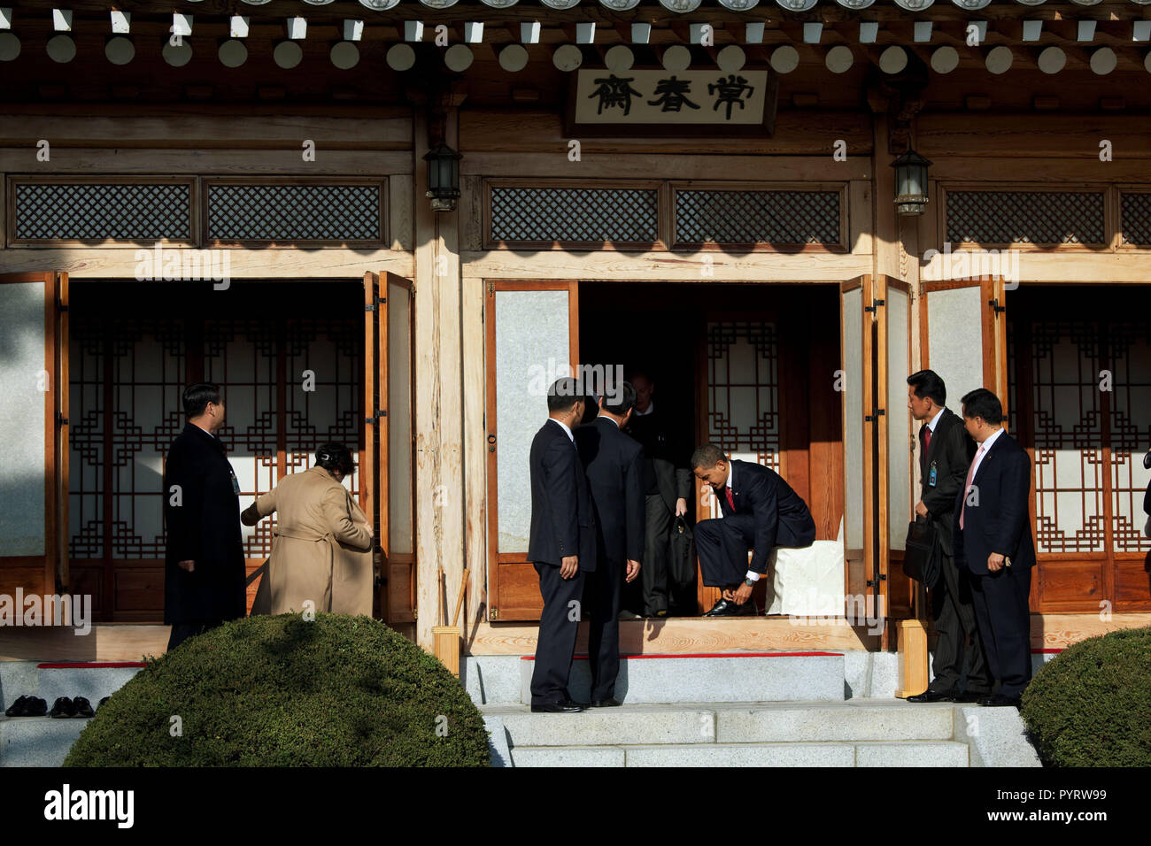 President Barack Obama puts his shoes back on after an official luncheon with South Korean President Lee Myung-bak at the Blue House in Seoul, South Korea, Nov. 19, 2009. Stock Photo