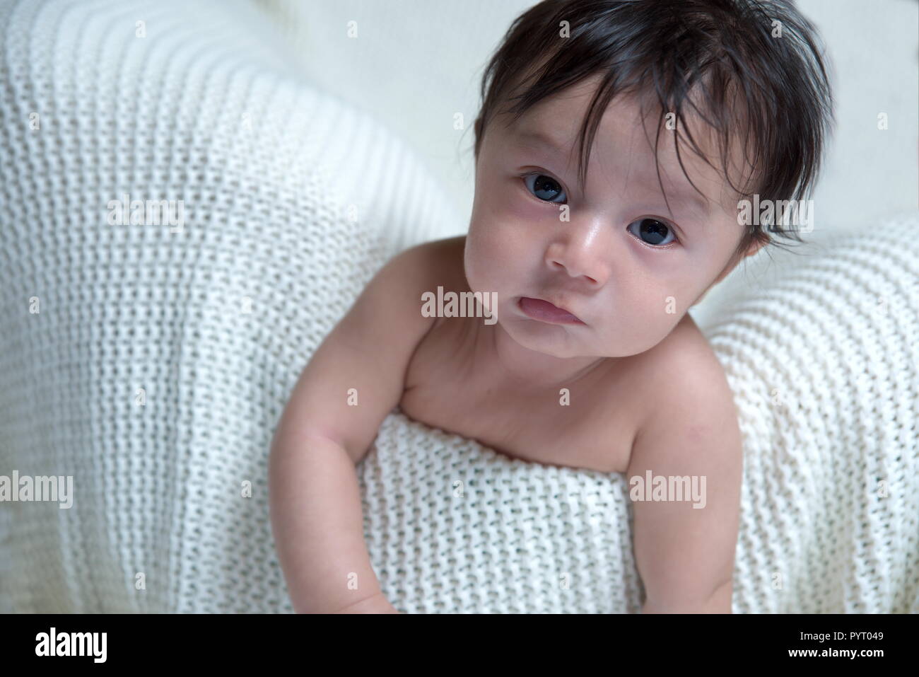 Cute little four month old baby in the Basket with white background on