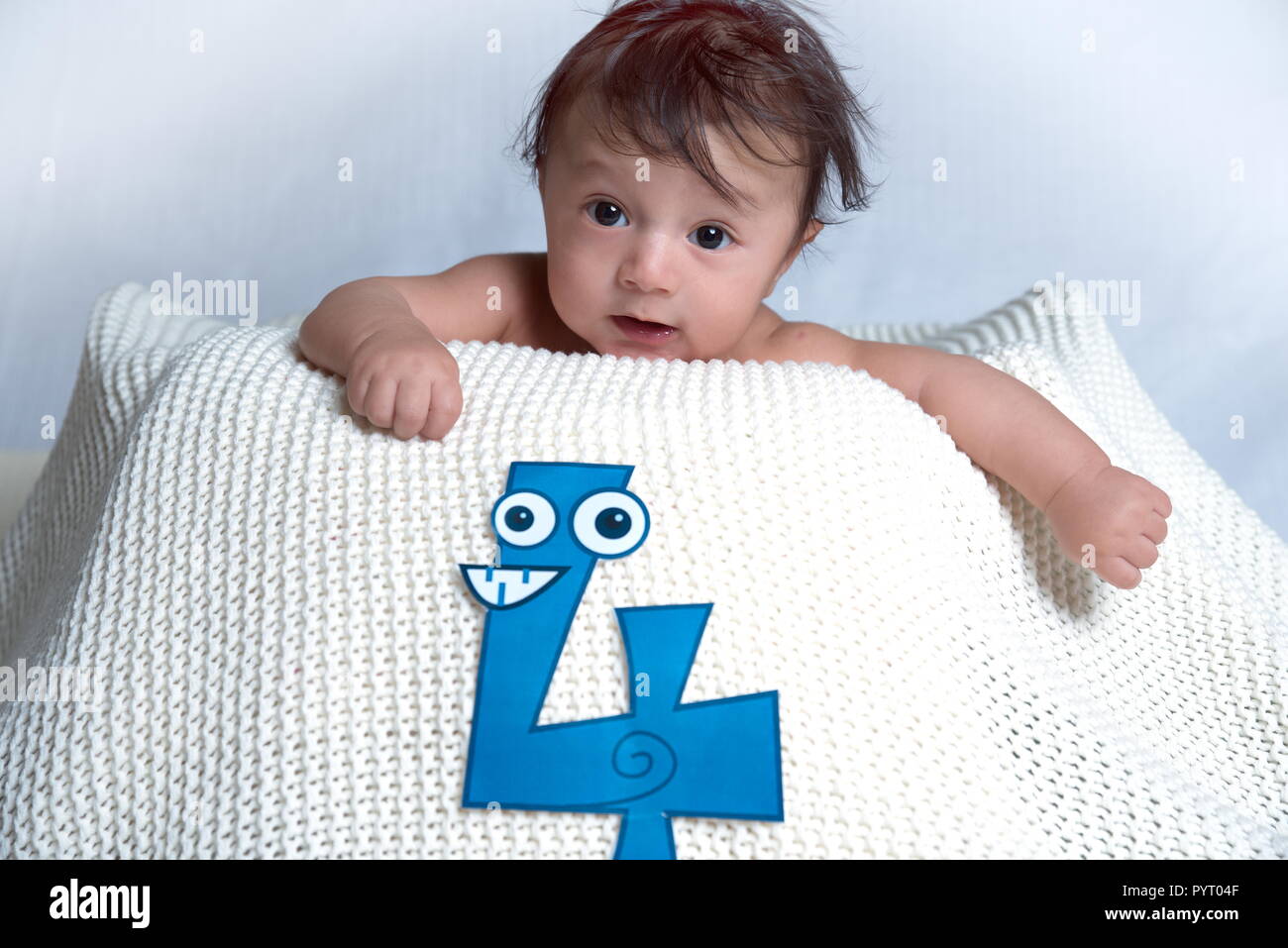 Cute little four month old baby in the Basket with white background on