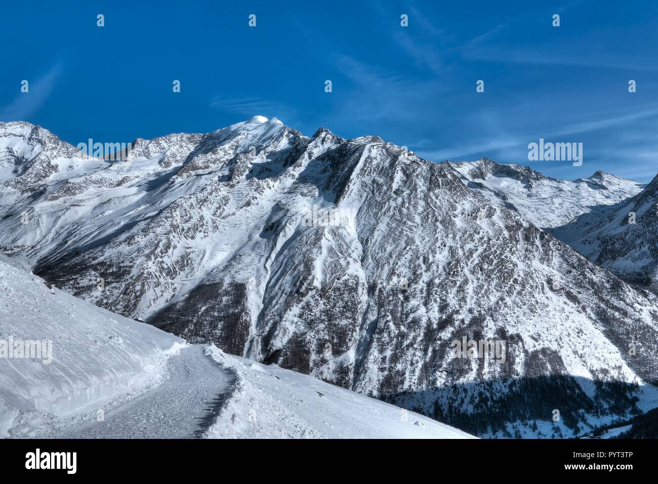 Snow trail in the Swiss Alps in winter, near Saas-Fee, Switzerland Stock Photo