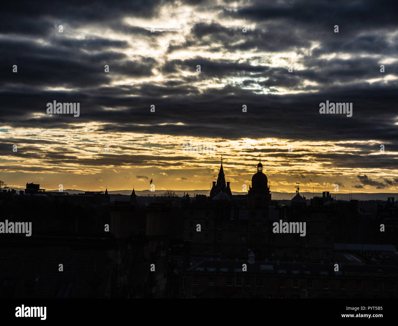 Southern Edinburgh skyline in silhouette from Edinburgh Castle, Scotland. Stock Photo