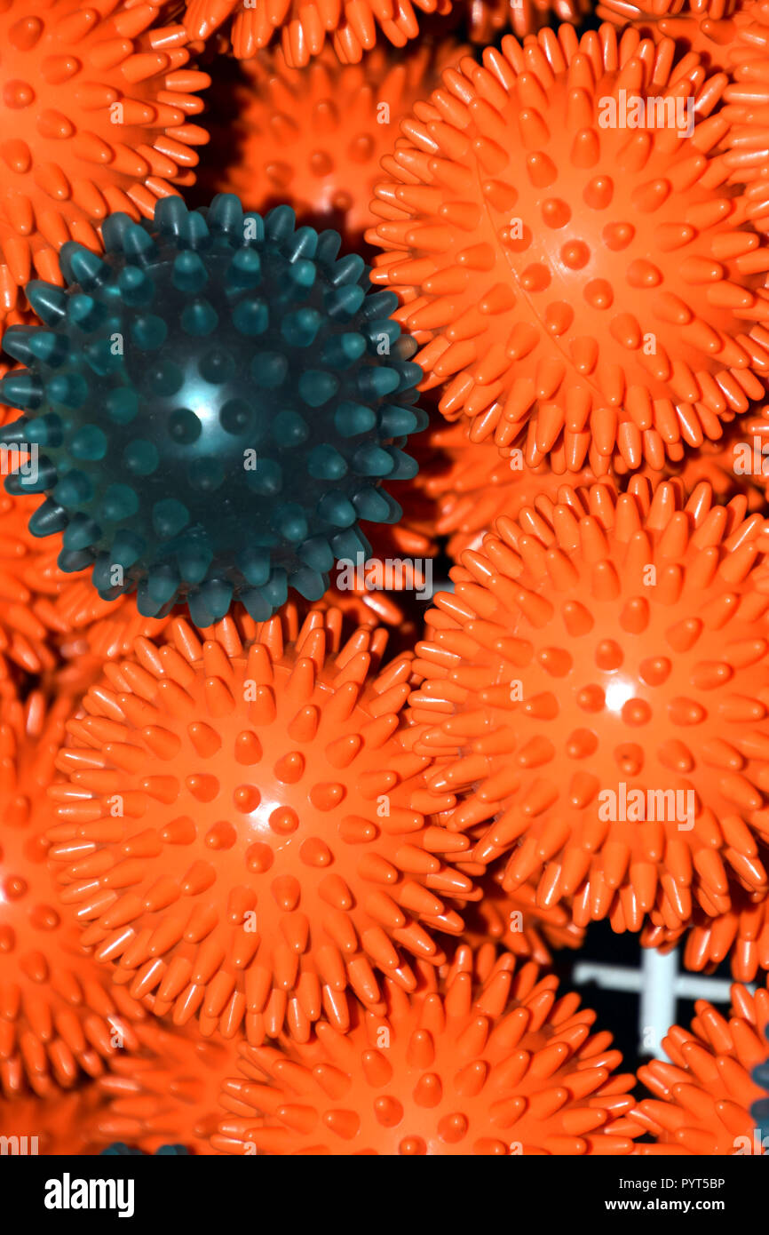 orange and blue prickly or therapy balls with flashlight reflections on them, different varieties fo massage balls Stock Photo