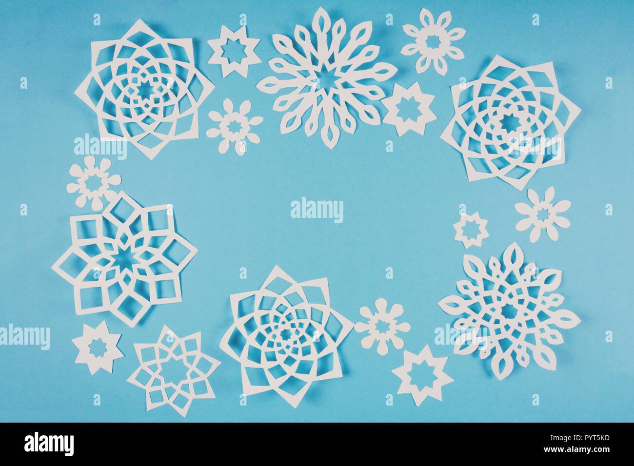 Paper snowflakes frame on blue background. Top view. Christmas ...