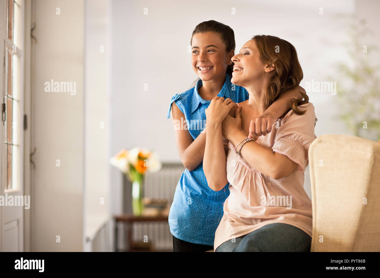 Portrait of woman at home with her daughter. Stock Photo