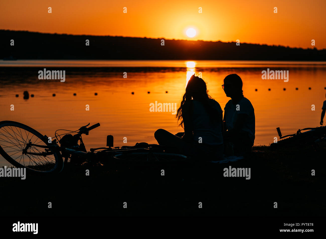 two girls are resting on the river bank Stock Photo - Alamy