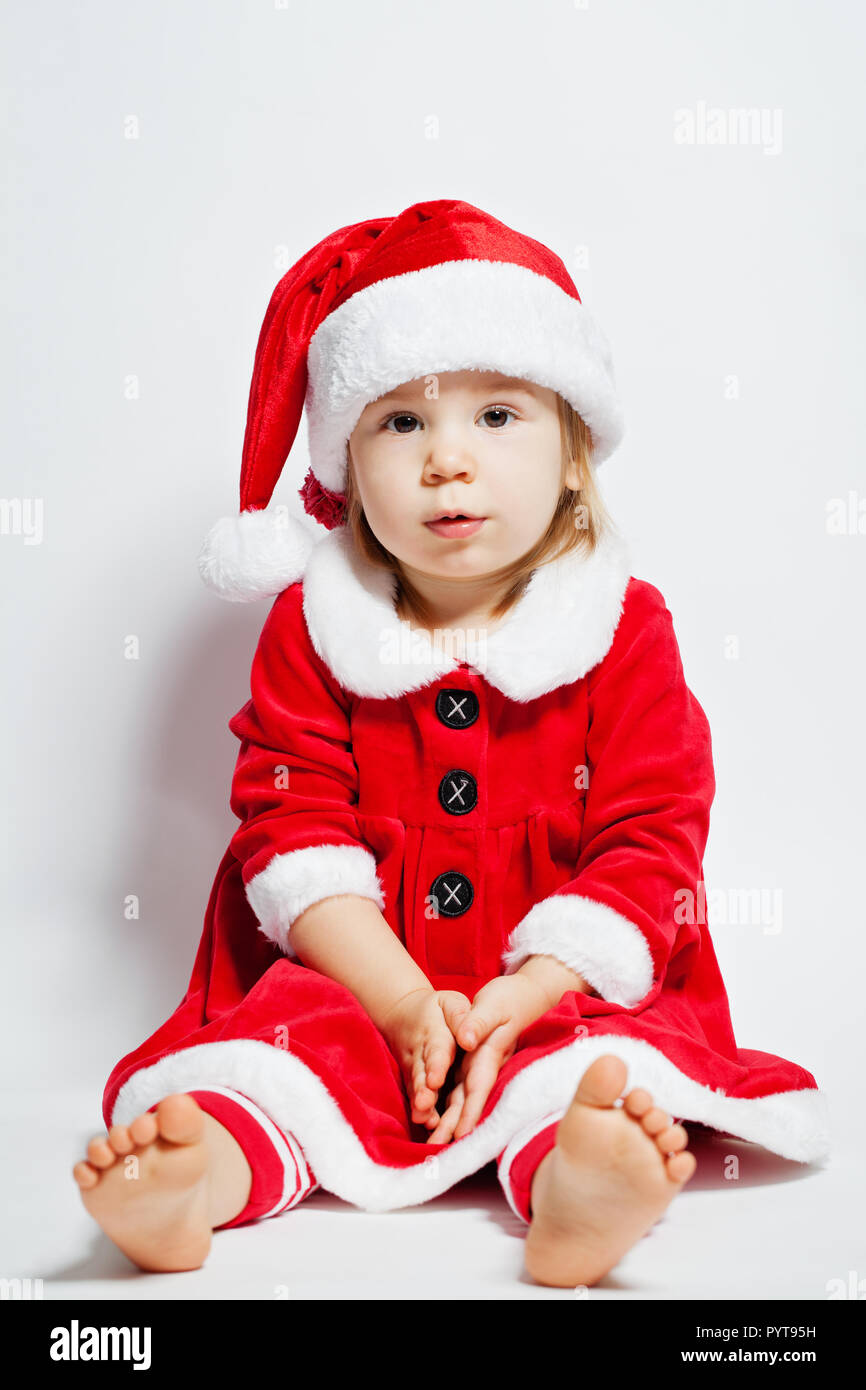 Cheerful baby in Santa hat on white background Stock Photo