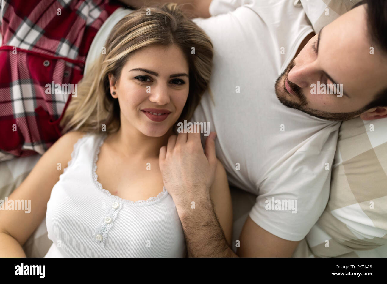 Young attractive couple having romantic time in bed Stock Photo