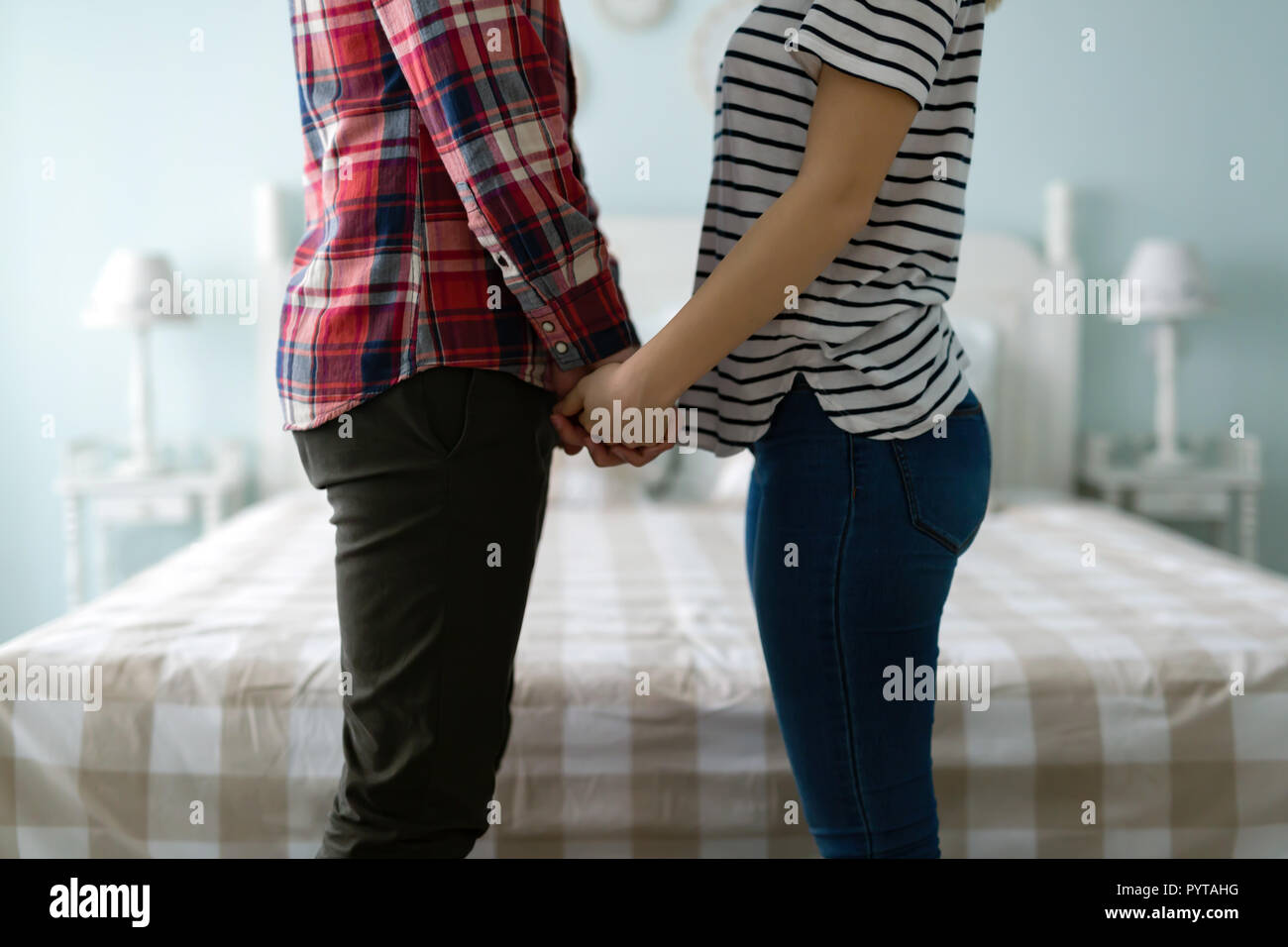 Portrait of man and woman in bedroom Stock Photo