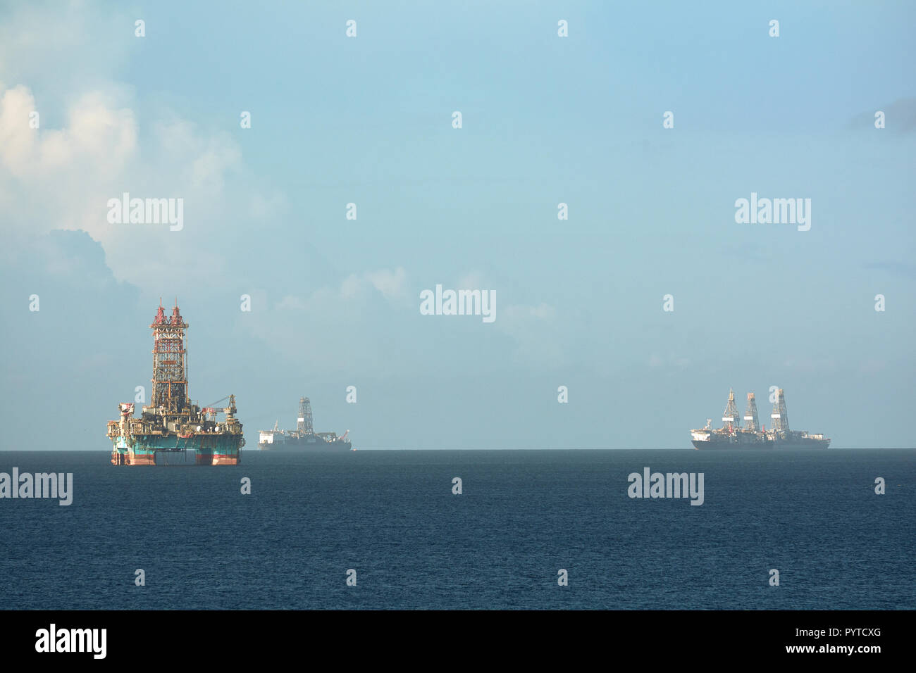 Offshore oil rig and drilling vessels in Chaguaramas Bay, Trinidad and Tobago working on oil industry project at sea. Stock Photo