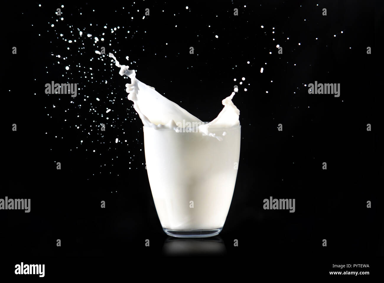 Glass of milk with splash on dark background Vector Image