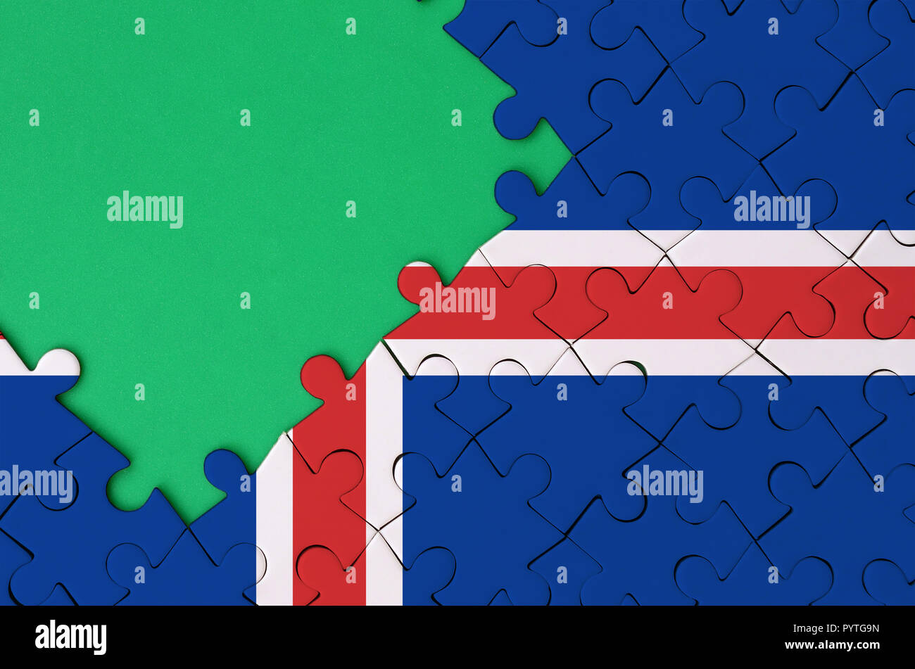 Iceland flag is depicted on a completed jigsaw puzzle with free green ...