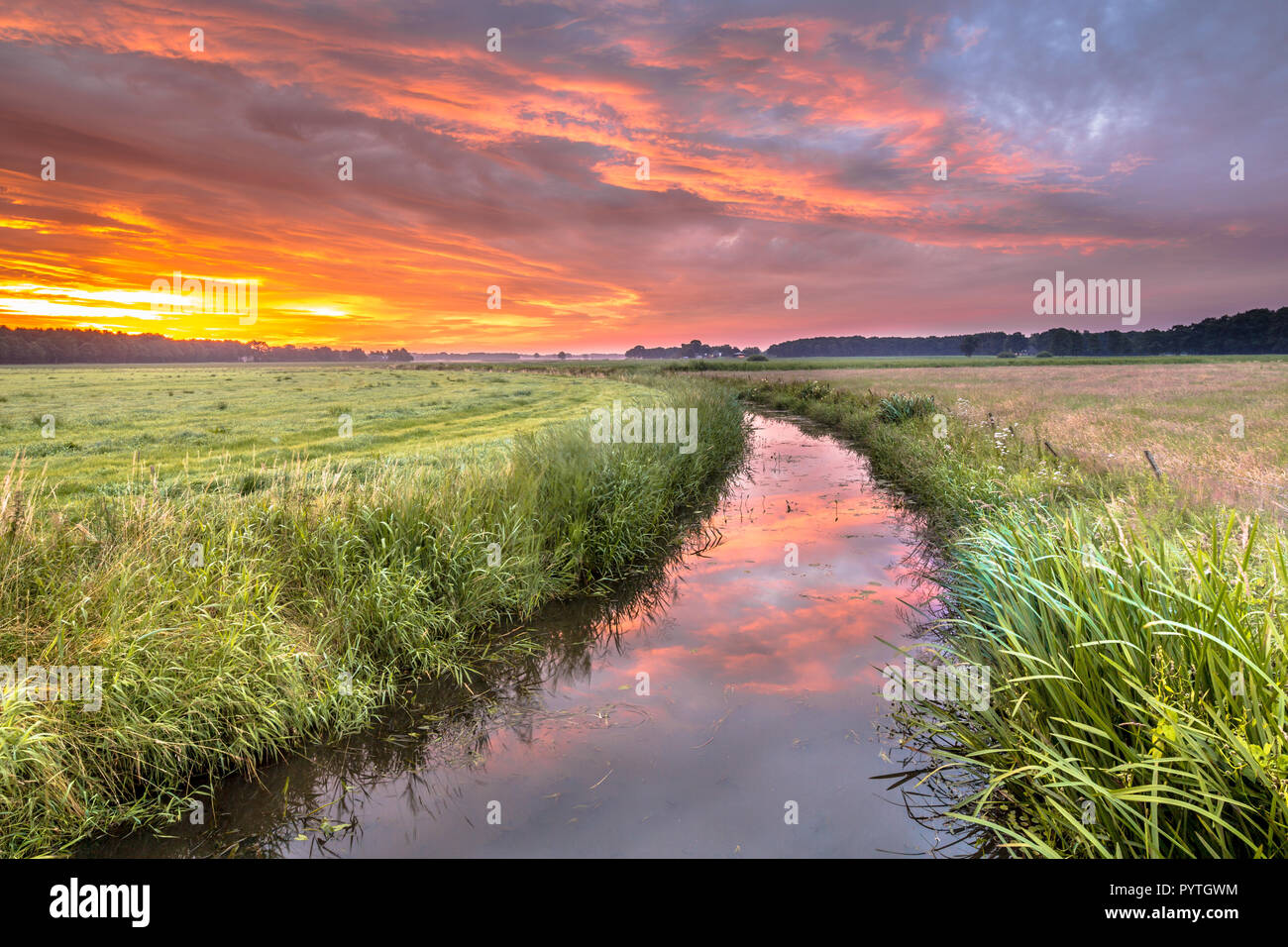 Spiritual voyage concept  summer sunrise over lowland river Grootdiep near Oosterwolde, Friesland, Netherlands Stock Photo