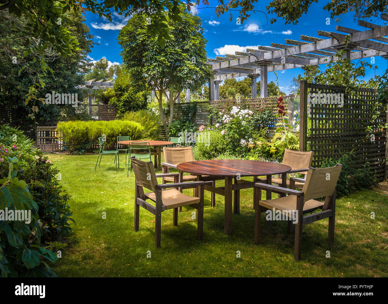 Home Backyard With Modern Garden Table Set In Sunny A Lush Garden With home-backyard-with-modern-garden-table-set-in-sunny-a-lush-garden-with