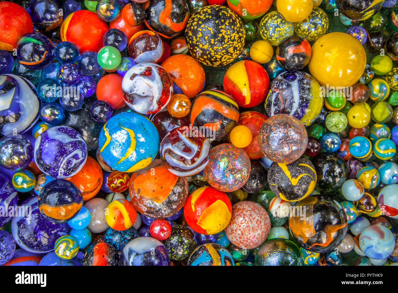 colorful Glass marbles of different sizes in a color pattern as