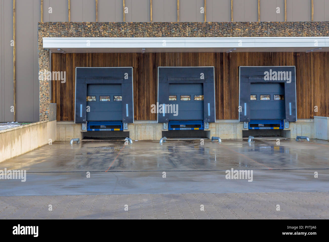 Three loading docks in a modern small business commercial building Stock Photo