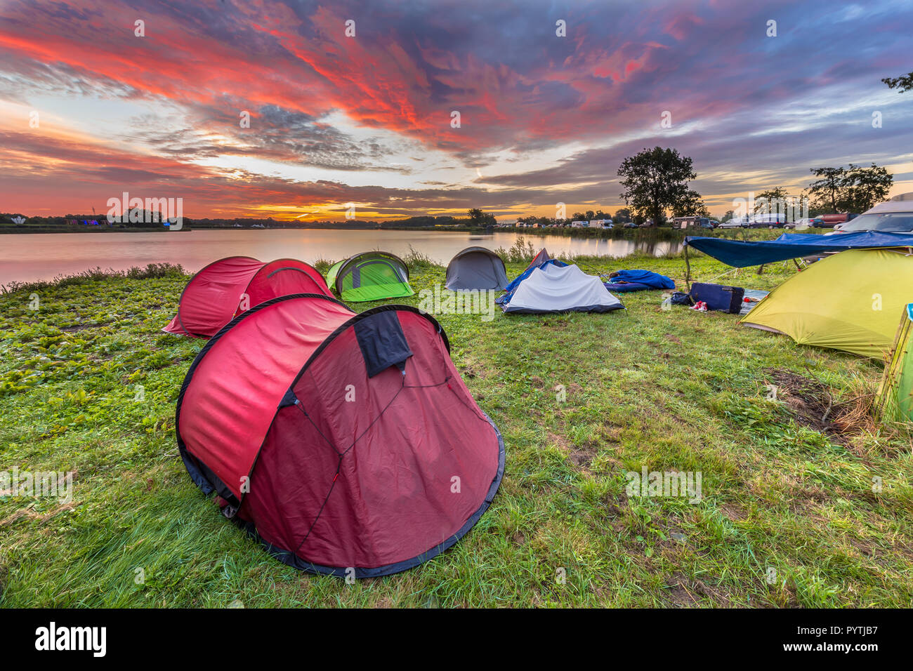 Dome tents camping near lake on a music festival camp site under