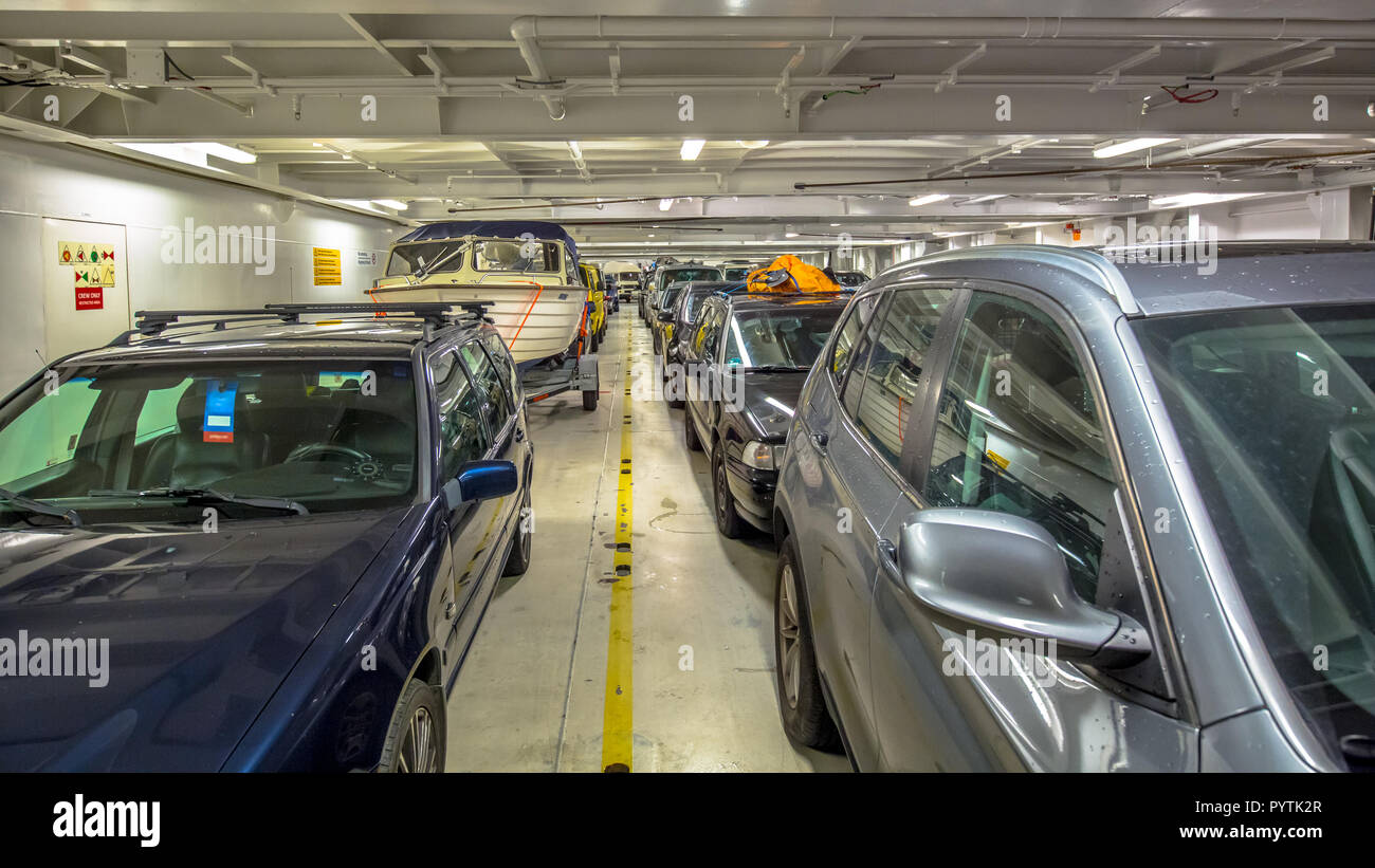 Passenger cars in interior of marine ferry in Europe Stock Photo