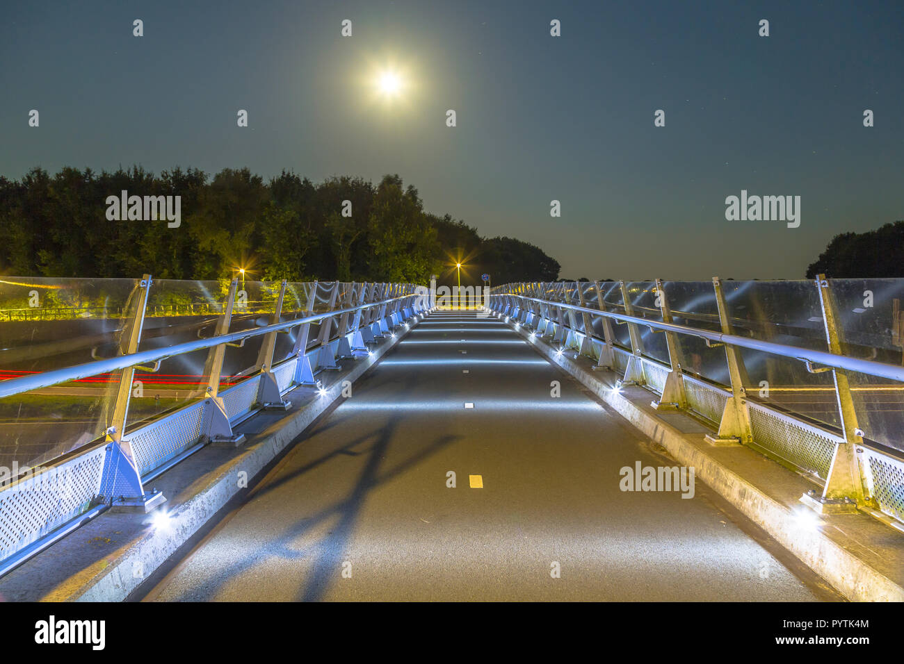 Cycling bridge with low level illumination to prevent disturbing of  migration route of nocturnal wildlife like bats and owls Stock Photo