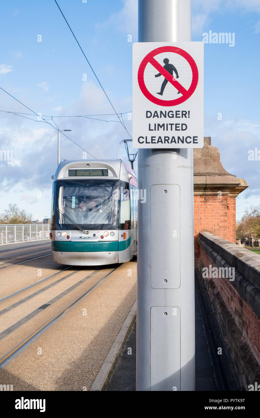 Danger Limited Clearance sign notifying pedestrians not to proceed beyond this point and onto the tramline, Nottingham, England, UK Stock Photo