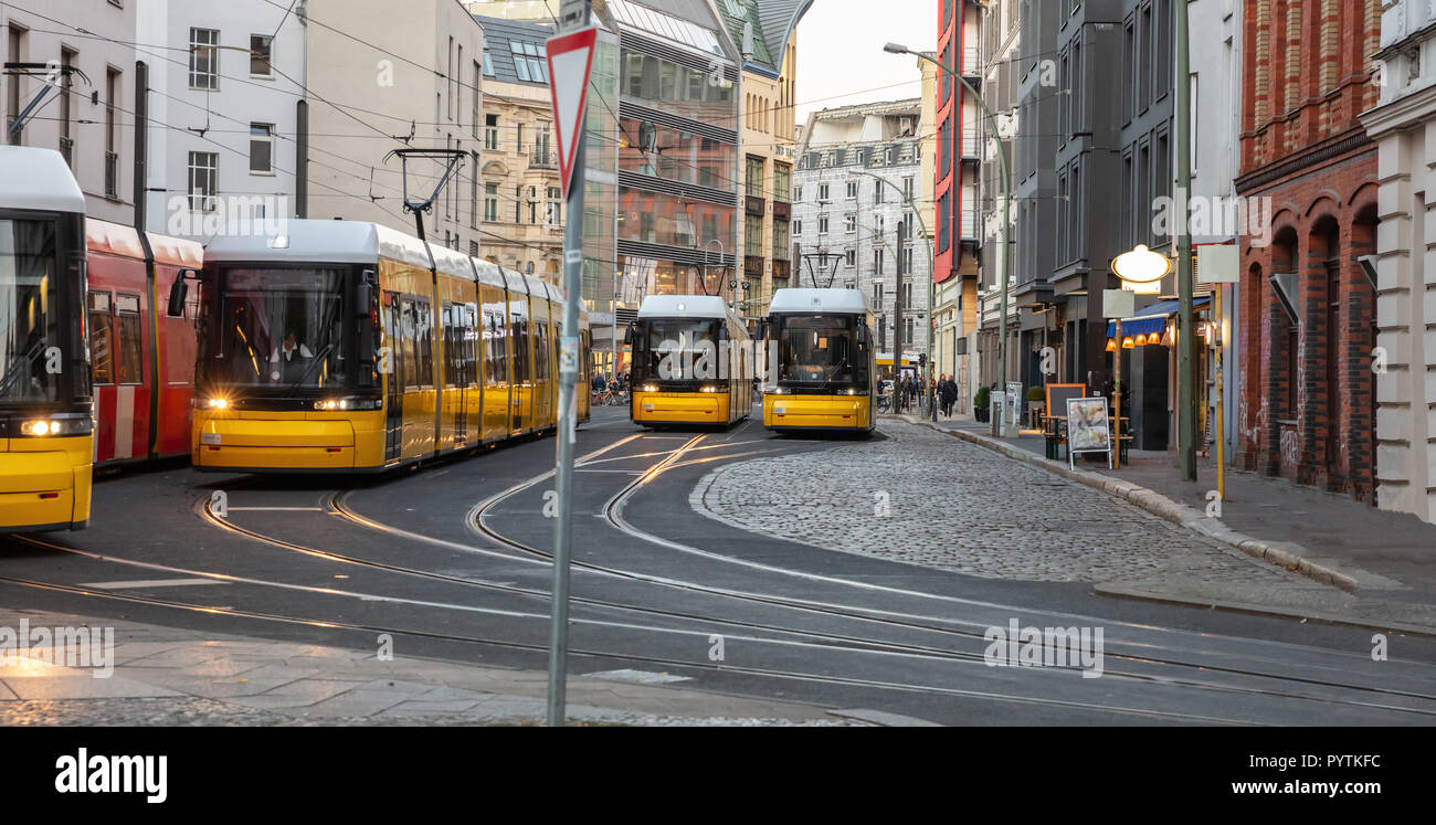 Yellow trams in the city center, office buildings background, Berlin Stock Photo