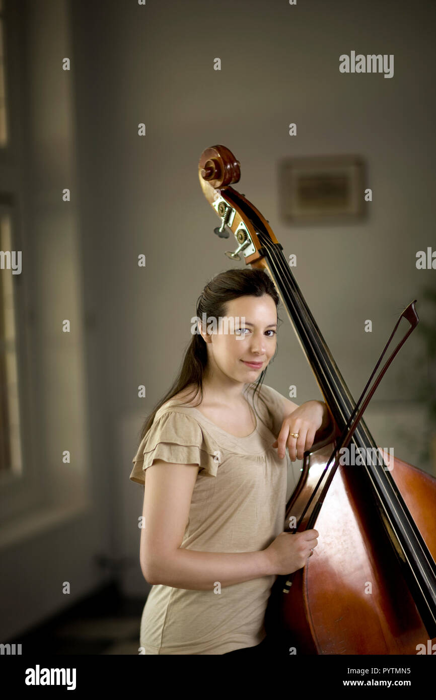 Woman playing her double bass. Stock Photo