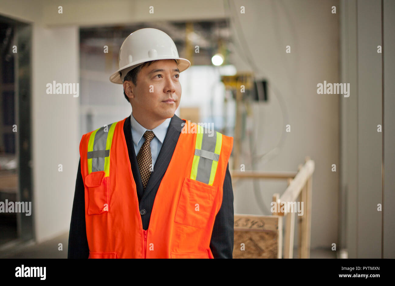 Middle aged businessman observing a construction site. Stock Photo