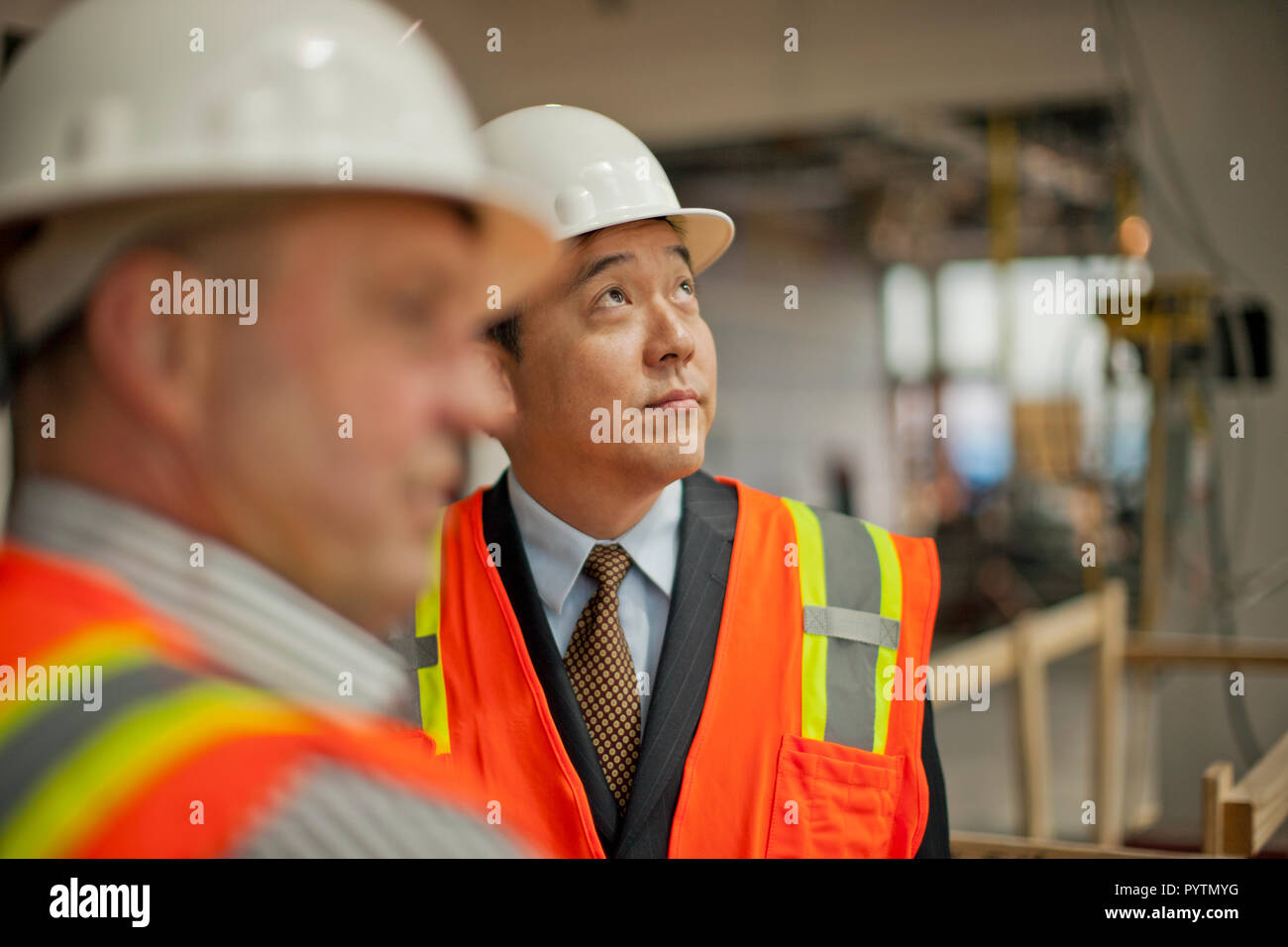 Middle aged businessman observing a construction site. Stock Photo