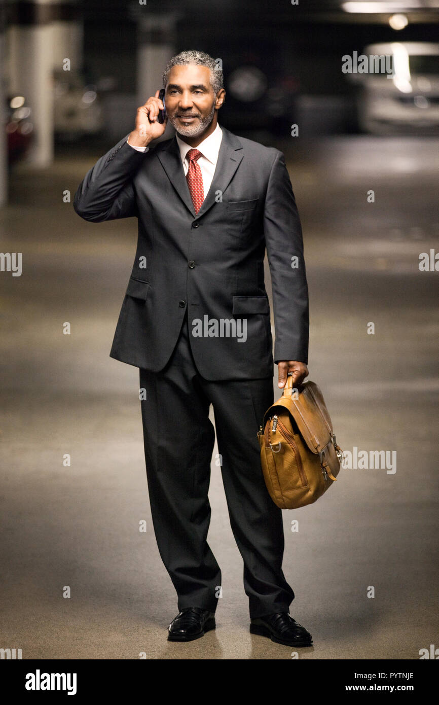 Smiling businessman talking on a cell phone. Stock Photo