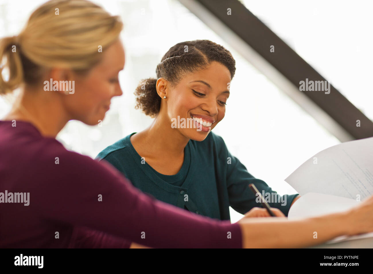 Happy colleagues working together on a project. Stock Photo